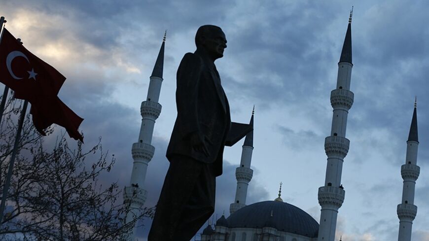 A statue of modern Turkey's founder Ataturk and a mosque in the background are pictured in a square where Turkish Prime Minister Tayyip Erdogan (not pictured) is to attend an election rally of his of ruling AK Party (AKP) in Kirikkale, central Turkey March 4, 2014. Turkey will hold municipal election on March 30. REUTERS/Umit Bektas (TURKEY - Tags: POLITICS ELECTIONS TPX IMAGES OF THE DAY) - RTR3G17X