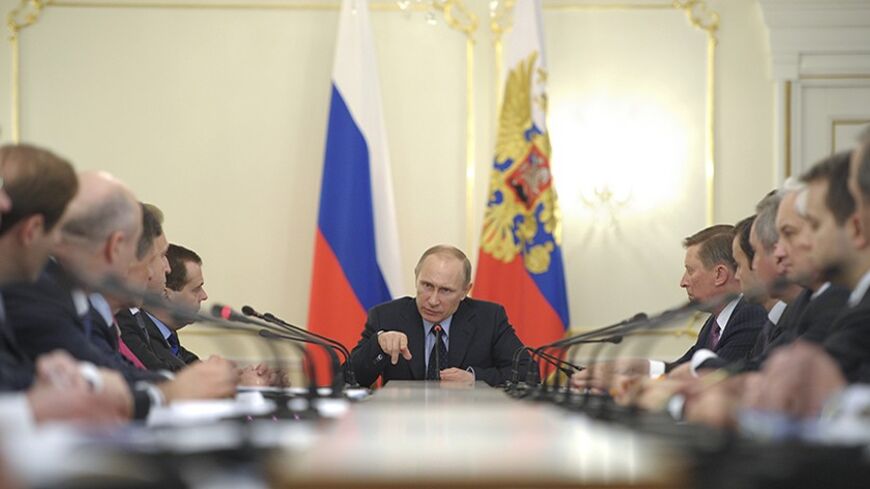 Russian President Vladimir Putin chairs a Russian government meeting in the Novo-Ogaryovo residence outside Moscow March 5, 2014. Putin said on Wednesday he did not want political tension to detract from economic cooperation with Russia's "traditional partners", signalling he hopes to avoid spillover from a bitter dispute with the West over Ukraine.  REUTERS/Alexei Druzhinin/RIA Novosti/Kremlin (RUSSIA - Tags: BUSINESS POLITICS) THIS IMAGE HAS BEEN SUPPLIED BY A THIRD PARTY. IT IS DISTRIBUTED, EXACTLY AS RE