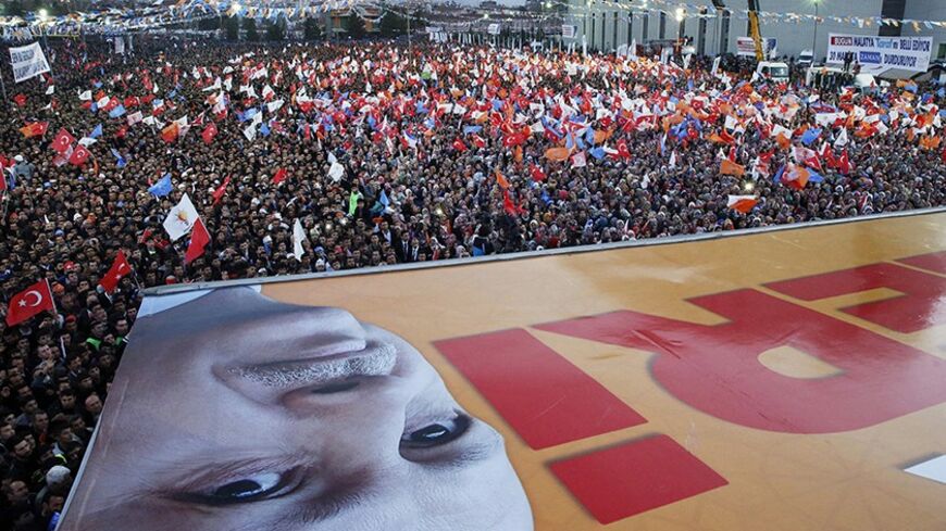 Supporters of ruling AK Party (AKP) listen as Turkey's Prime Minister Tayyip Erdogan (his portrait seen on foreground) addresses during an election rally in Malatya March 6, 2014. Turkey will hold municipal elections on March 30. REUTERS/Umit Bektas (TURKEY - Tags: POLITICS ELECTIONS TPX IMAGES OF THE DAY) - RTR3G4X8