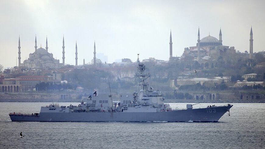 U.S. Navy guided-missile destroyer USS Truxtun, with Istanbul's historical monuments Sultanahmet mosque, known as Blue mosque, (L) and Hagia Sophia museum (R) in the background, sets sail in the Bosphorus, on its way to the Black Sea March 7, 2014.  A U.S. warship passed through Turkey's Bosphorus straits on Friday on its way to the Black Sea, in what the U.S. military has described as a "routine" deployment scheduled well before the crisis in Ukraine. Washington announced the deployment on Thursday, a day 