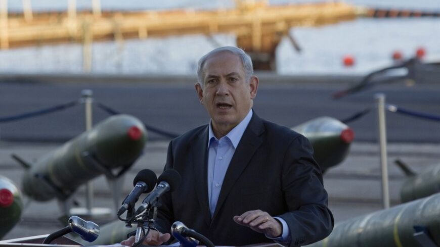 Israel's Prime Minister Benjamin Netanyahu speaks to the media in front of a display of M302 rockets, found aboard the Klos C ship, at a navy base in the Red Sea resort city of Eilat March 10, 2014. Netanyahu, displaying on Monday what Israel said were seized Iranian-supplied missiles bound for militants in Gaza, called on the West not to be fooled by Tehran's diplomatic outreach over its nuclear programme. REUTERS/Amir Cohen (ISRAEL - Tags: POLITICS MILITARY CIVIL UNREST) - RTR3GGS8