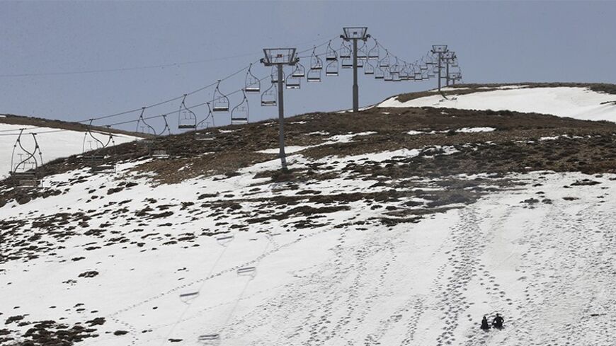 A general view shows a closed ski resort due to the lack of snow in north of Beirut, Lebanon March 7, 2014. The mountains north of Beirut, usually covered in a heavy layer of snow and brimming with skiers, snowboarders and other winter tourists, are brown, muddy and completely empty this season. An unseasonably warm and dry winter - the mildest in decades - has decimated seasonal tourism in Lebanon and endangered the harvest of its vineyards which export prize-winning wines around the world. Picture taken M
