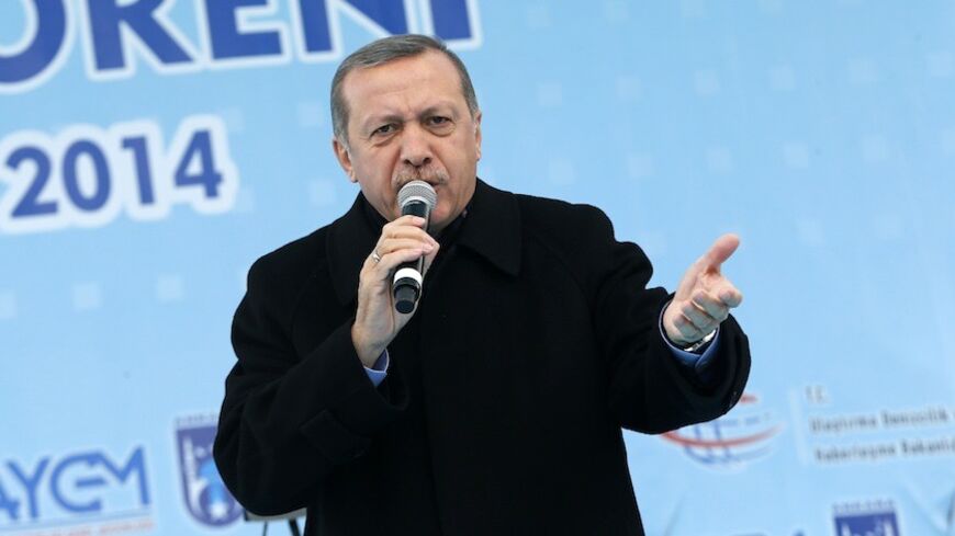 Turkey's Prime Minister Tayyip Erdogan addresses the crowd during an opening ceremony of a new metro line in Ankara  March 13, 2014. A defiant Prime Minister Tayyip Erdogan, already battling a damaging corruption scandal weeks ahead of elections, cast the latest unrest as part of a plot against the state. REUTERS/Umit Bektas (TURKEY - Tags: POLITICS TRANSPORT CIVIL UNREST) - RTR3GWD4
