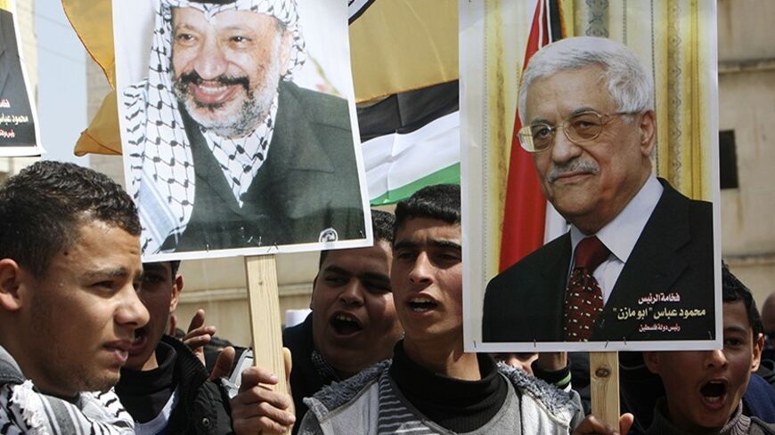 Palestinian Fatah supporters hold placards showing pictures of President Mahmoud Abbas (R) and late leader Yasser Arafat during a rally in support of Abbas in the West Bank village of Tubas near Jenin March 16, 2014. With pessimism growing over future of Middle East peace talks, U.S. President Barack Obama will meet Abbas in Washington on Monday to try to break stalemate. REUTERS/Abed Omar Qusini (WEST BANK - Tags: POLITICS) - RTR3HADW