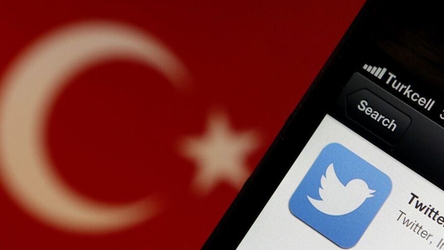 A Twitter logo on an iPhone display is pictured next to a Turkish flag in this photo illustration taken in Istanbul March 21, 2014. Turkey's courts have blocked access to Twitter a little over a week before elections as Prime Minister Tayyip Erdogan battles a corruption scandal that has seen social media awash with alleged evidence of government wrongdoing. The ban came hours after a defiant Erdogan, on the campaign trail ahead of key March 30 local elections, vowed to "wipe out" Twitter and said he did not