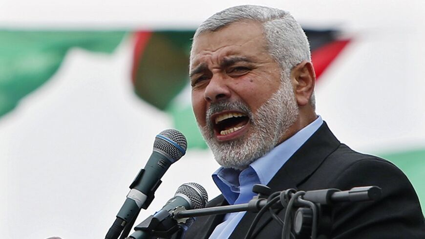 Ismail Haniyeh, prime minister of the Hamas Gaza government, talks to his supporters during a Hamas rally marking the anniversary of the death of its leaders killed by Israel, in Gaza City March 23, 2014. REUTERS/Mohammed Salem (GAZA - Tags: POLITICS CIVIL UNREST ANNIVERSARY) - RTR3I85L
