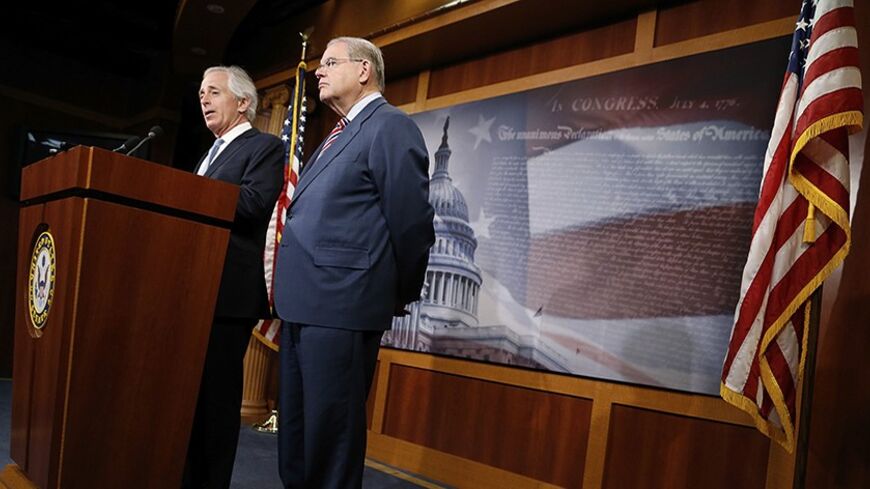 U.S. Senate Foreign Relations Committee Chairman Robert Menendez (D-NJ) (R) and ranking member Senator Bob Corker (R-TN) (L) hold a news conference after a Senate vote on an aid package for Ukraine at the U.S. Capitol in Washington March 27, 2014. REUTERS/Jonathan Ernst    (UNITED STATES - Tags: POLITICS) - RTR3IVO5
