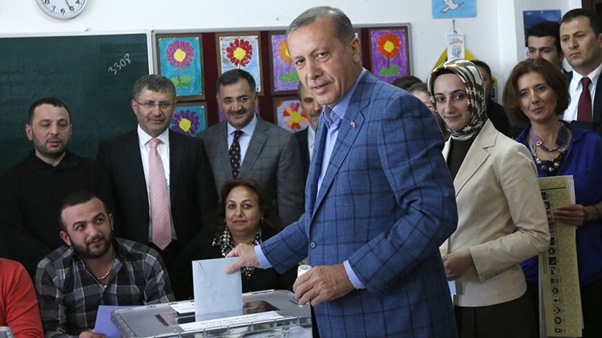 Turkey's Prime Minister Tayyip Erdogan casts his ballot at a polling station during the municipal elections in Istanbul March 30, 2014. Erdogan looks set to win Sunday's municipal elections that have become a crisis referendum on his 10-year rule as he tries to ward off graft allegations and stem a stream of damaging security leaks. REUTERS/Murad Sezer (TURKEY  - Tags: POLITICS ELECTIONS)   - RTR3J6X5