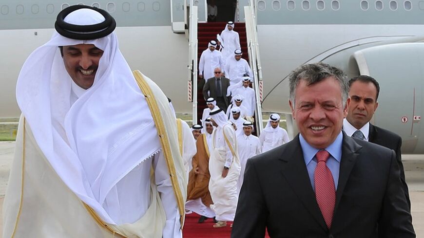 Jordan's King Abdullah (R) walks with Qatar's Emir Sheikh Tamim Bin Hamad Al Thani after his arrival at Amman airport March 30, 2014. REUTERS/Yousef Allan/Royal Palace/Handout (JORDAN - Tags: POLITICS) FOR EDITORIAL USE ONLY. NOT FOR SALE FOR MARKETING OR ADVERTISING CAMPAIGNS. ATTENTION EDITORS - THIS PICTURE WAS PROVIDED BY A THIRD PARTY. REUTERS IS UNABLE TO INDEPENDENTLY VERIFY THE AUTHENTICITY, CONTENT, LOCATION OR DATE OF THIS IMAGE. THIS PICTURE IS DISTRIBUTED EXACTLY AS RECEIVED BY REUTERS, AS A SER