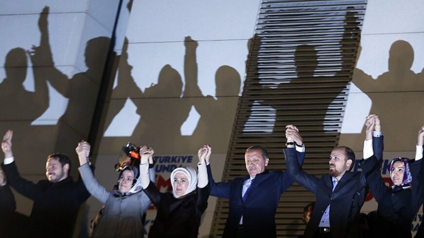 Turkey's Prime Minister Tayyip Erdogan (3rd R) greets his supporters with his family members in Ankara March 31, 2014. Tayyip Erdogan's ruling AKP party appeared on Sunday to be heading for a clear victory in local polls that have become a referendum on a prime minister facing corruption scandals and security leaks he blames on "traitors" embedded in state bodies. Erdogan's family members from L to R are his son-in-law Berat Albayrak, his daughter Esra Erdogan Albayrak, his wife Emine, his son Bilal and his