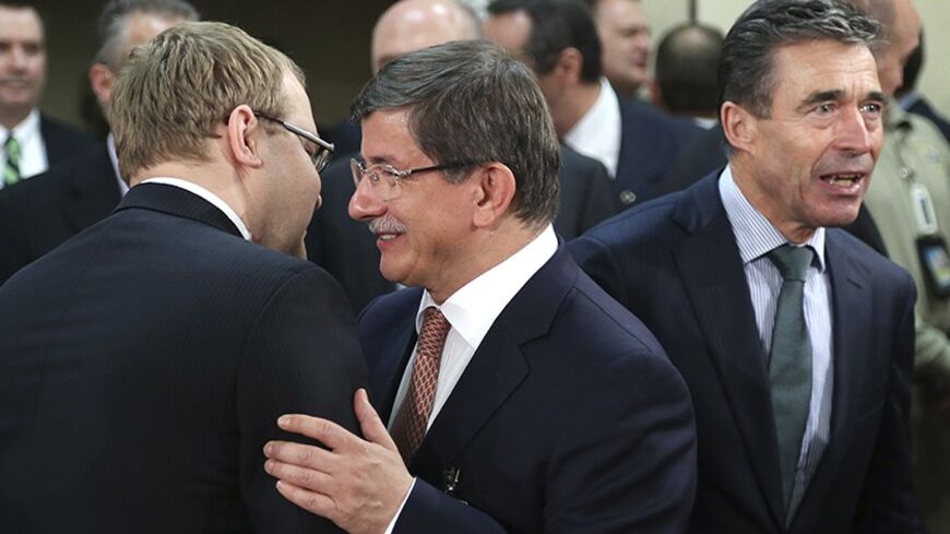 (L-R) Estonia's Foreign Minister Urmas Paet greets Turkish Foreign Minister Ahmet Davutoglu next to NATO Secretary General Anders Fogh Rasmussen during a NATO foreign ministers meeting at the Alliance headquarters in Brussels April 1, 2014. NATO will decide new steps on Tuesday to reinforce eastern European countries worried by Russia's annexation of Crimea, and on how to bolster Ukraine's armed forces.    REUTERS/Francois Lenoir (BELGIUM  - Tags: POLITICS MILITARY) - RTR3JGMR