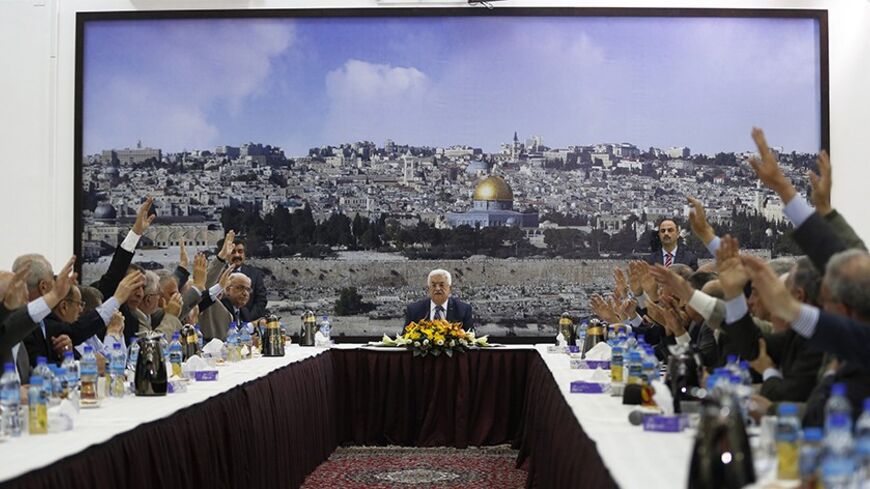 Palestinian leaders vote for international conventions as Palestinian president Mahmoud Abbas (C) chairs a meeting in the West Bank City of Ramallah April 1, 2014. Abbas signed more than a dozen international conventions on Tuesday citing anger at Israel's delay of a prisoner release, in a move jeopardised U.S. efforts to salvage fragile peace talks. REUTERS/Mohamad Torokman (WEST BANK - Tags: POLITICS) - RTR3JIOJ