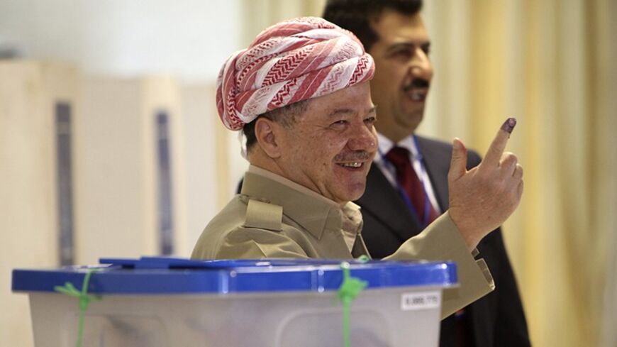 Iraq's Kurdistan President Masoud Barzani shows his ink-stained finger at a polling station in Arbil, capital of the autonomous Kurdistan region, about 350 km (217 miles) north of Baghdad, September 21, 2013. Iraqi Kurds went to the polls on Saturday to vote for a new parliament at a time when their oil-producing region is seeking greater autonomy from Baghdad, against a backdrop of violent instability in the rest of Iraq and the wider Middle East. REUTERS/Azad Lashkari  (IRAQ - Tags: ELECTIONS POLITICS) - 