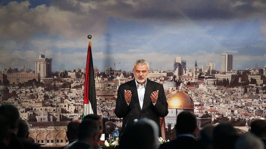 Ismail Haniyeh, prime minister of the Hamas Gaza government, prays before delivering a speech in Gaza City October 19, 2013. Haniyeh urged rival Palestinian President Mahmoud Abbas to speed up the implementation of the faltering Egyptian-brokered unity deal to heal six years of political rifts. REUTERS/Mohammed Salem (GAZA - Tags: POLITICS) - RTX14GN2