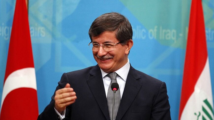 Turkish Foreign Minister Ahmet Davutoglu addresses the media during a joint news conference with Iraq's Foreign Minister Hoshiyar Zebari (not seen) at the Foreign Ministry headquarters in Baghdad, November 10, 2013.  REUTERS/Thaier Al-Sudani (IRAQ - Tags: POLITICS) - RTX157TK