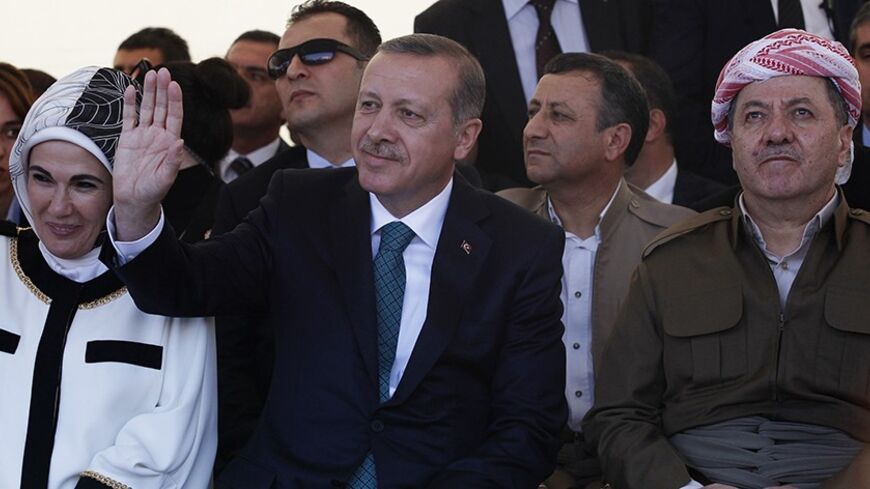 Turkey's Prime Minister Tayyip Erdogan and President of Iraqi Kurdistan Masoud Barzani (R) attend a ceremony with Erdogan's wife Emine Erdogan in Diyarbakir November 16, 2013. The president of Iraqi Kurdistan called on Turkey's Kurds to back a flagging peace process with Ankara on Saturday, making his first visit to southeastern Turkey in two decades in a show of support for Prime Minister Tayyip Erdogan. Barzani's trip to Diyarbakir, the main city in Turkey's Kurdish-dominated southeast, comes as Ankara fi