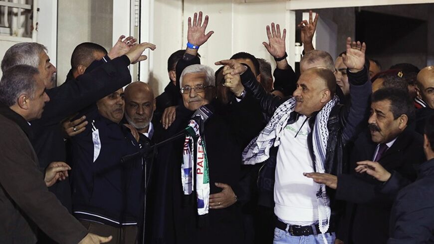Palestinian President Mahmoud Abbas (C) welcomes Palestinian prisoners released from Israeli prisons in the West Bank city of Ramallah early December 31, 2013. Israel set free 26 Palestinian prisoners on Tuesday as part of U.S.-brokered peace efforts, after pledging to press ahead with plans to build more homes in Jewish settlements. REUTERS/Mohamad Torokman (WEST BANK - Tags: POLITICS) - RTX16XON