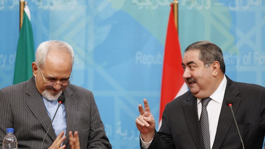 Iran's Foreign Minister Mohammed Javad Zarif (L) and Iraq's Foreign Minister Hoshiyar Zebari attend a joint news conference in Baghdad January 14, 2014. REUTERS/Thaier Al-Sudani (IRAQ - Tags: POLITICS) - RTX17DOX