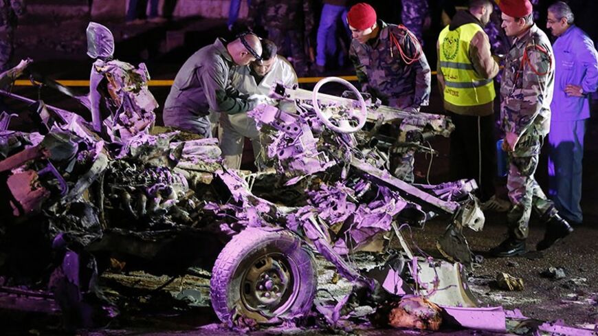 Forensic inspectors and Lebanese army soldiers  inspect the wreckage of a van at the site of an explosion in Choueifat, south of the capital February 3, 2014. A suicide bomber killed himself and one other person when he detonated explosives in a van in southern Beirut on Monday, a Lebanese security source said. Lebanese television footage showed the chassis of a vehicle with no roof. Smoke rose in the air and debris lay on a street. Body parts, including a head, were on the road. REUTERS/Mohamed Azakir  (LE