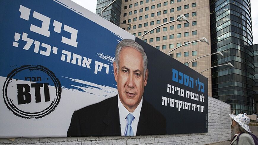 A woman looks at a billboard calling on Israel's Prime Minister Benjamin Netanyahu to end the Israeli-Palestinian conflict, in Tel Aviv February 2, 2014. Breaking the Impasse, a group formed by Israeli businessmen, put a triumphant-looking Netanyahu at the centre of the billboard posters and newspaper ads calling on him to end the decades-old conflict with the Palestinians. "Only you can do it Bibi!" say the ads, using Netanyahu's nickname. Picture taken February 2, 2014. REUTERS/Baz Ratner (ISRAEL - Tags: 
