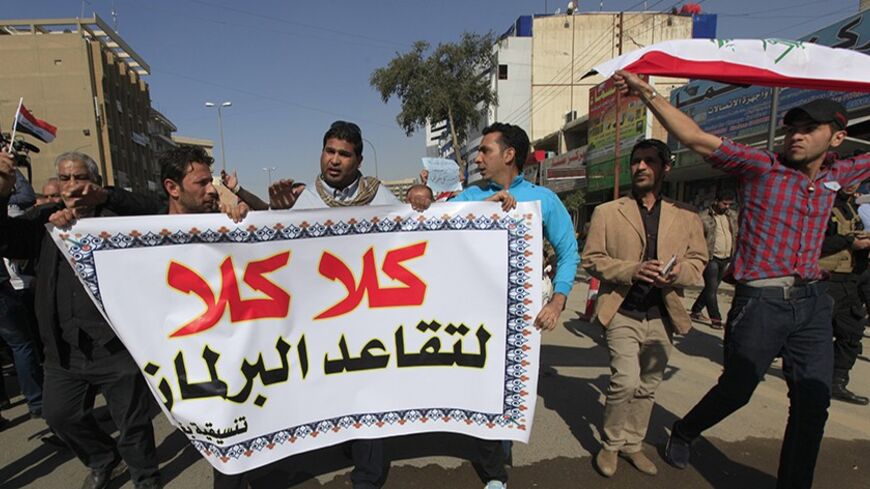 Protesters march during a demonstration demanding the abolition of a law granting pensions to parliamentarians in Baghdad, February 15, 2014. The banner reads, "No to the pensions of parliamentarians." REUTERS/Ahmed Saad (IRAQ - Tags: CIVIL UNREST POLITICS BUSINESS EMPLOYMENT) - RTX18V53