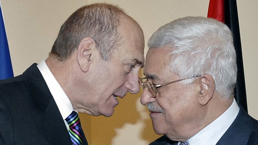 Israel's Prime Minister Ehud Olmert (L) speaks with Palestinian President Mahmoud Abbas during their meeting in Jerusalem January 8, 2008, in this picture released by the Israeli Government Press Office (GPO). Olmert and Abbas met on Tuesday, the eve of a visit by President George W. Bush, to try to get peace talks moving.  REUTERS/Moshe Milner/GPO/Handout (JERUSALEM) ISRAEL OUT.  EDITORIAL USE ONLY. NOT FOR SALE FOR MARKETING OR ADVERTISING CAMPAIGNS. - RTX5C98
