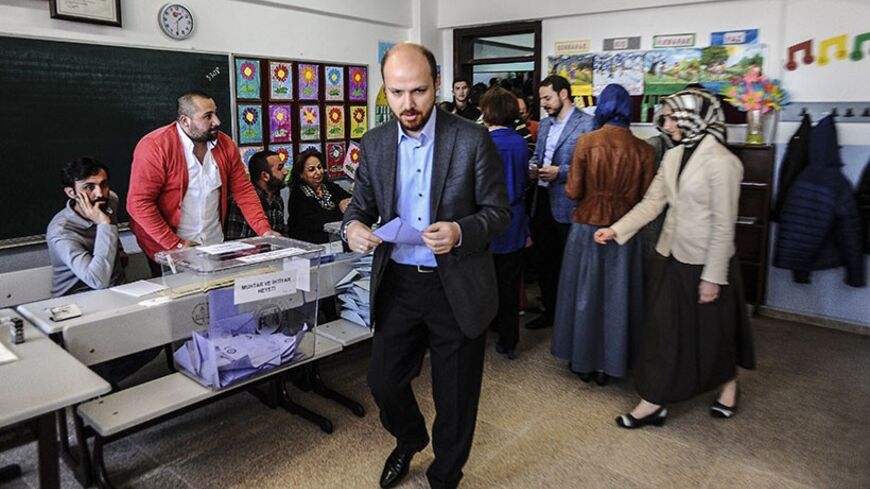 Bilal Erdogan, the son of Turkish Prime Minister Recep Tayyip Erdogan (unseen) casts his ballot at a polling station in Istanbul on March 30, 2014, during municipal elections in Turkey ahead of a presidential vote in six months and parliamentary polls next year. Turkey's Premier Recep Tayyip Erdogan, embattled by protests and corruption scandals, faced a crucial popularity test today when over 50 million eligible voters cast their ballots in local elections. More than 50 million voters were to cast their ba