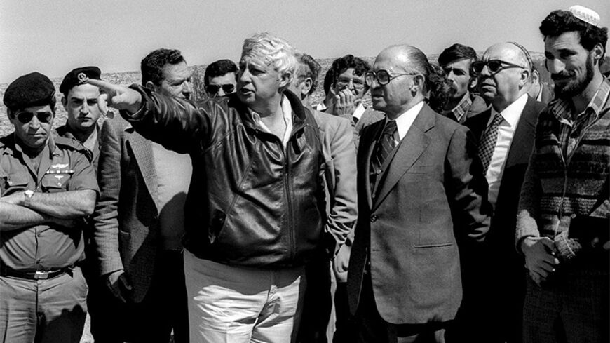 ELON MOREH, WEST BANK - FEBRUARY 27:  (FILE PHOTO)  Israeli Prime Minister Menachem Begin (C) with Interior Minsiter Yosef Burg (2nd R) and settler leader Benny Katzover (R) listens to an explanation by Agriculture Minister Ariel Sharon (2nd L) about the development February 27, 1981 of the permanent settlement of Elon Moreh east of the West Bank Palestinian town of Nablus. After being forcibly evacuated by the Israeli army from the nearby Sebastia train station seven times since the summer of 1974, the pio