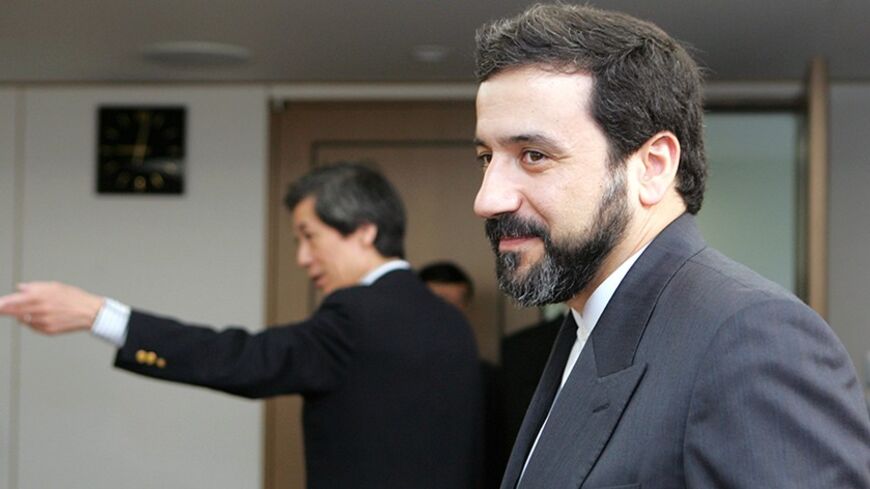 Iran's Deputy Foreign Minister Abbas Araghchi (R) is led by Japanese Deputy Minister for Foreign Affairs Tsuneo Nishida before their talks at the Foreign Ministry in Tokyo September 1, 2006.   REUTERS/Toru Hanai (JAPAN) - RTR1GVI6