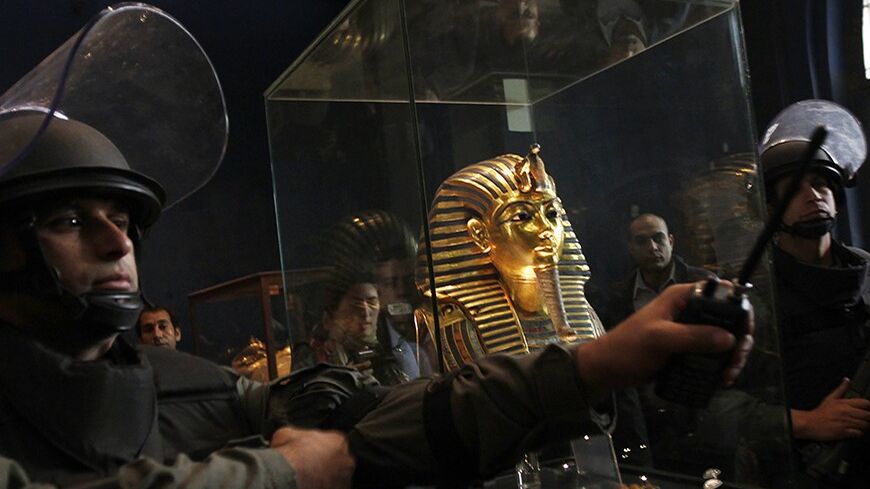 Egyptian Army special forces personnel stand guard beside a golden funerary mask of King Tutankhamun at the Egyptian Museum in Cairo February 16, 2011. Egypt's Antiquities Ministry has recovered some of the national treasures that went missing from the Egyptian Museum during an uprising which unseated Hosni Mubarak. The Ministry has found two of the eight missing artifacts outside the museum between a government building that got burned and the gift shop and will continue the search, Egypt's Minister of Ant
