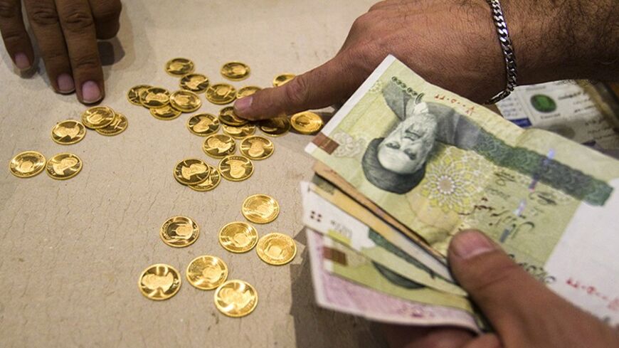 EDITORS' NOTE: Reuters and other foreign media are subject to Iranian restrictions on leaving the office to report, film or take pictures in Tehran.

A customer buys Iranian gold coins at a currency exchange office in Tehran's business district October 24, 2011. Iranian media reported last week that monetary authorities had reversed a six-month-old decision to cut interest on bank deposits, aiming to mop up excess cash in the economy and halt a dangerous rise of inflation. The news made sense to economists,