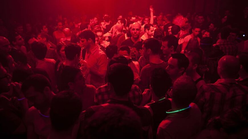 People dance at a gay party in a Tel Aviv night club January 20, 2012. Less than an hour away but a world apart from traditional places of pilgrimage in the Holy Land, Israel's free-wheeling city of Tel Aviv has become a Mediterranean hotspot for gay tourism.  Picture taken January 20, 2012.   REUTERS/Nir Elias (ISRAEL - Tags: SOCIETY ENTERTAINMENT TRAVEL) - RTR2WRZE