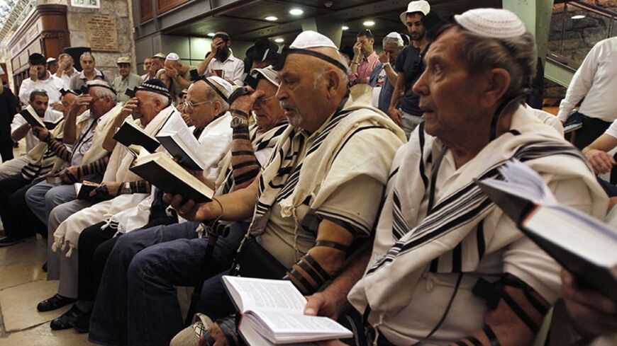 Holocaust survivors pray during their Bar Mitzvah ceremony at the Western Wall, Judaism's holiest prayer site, in Jerusalem's Old City October 22, 2012. On Monday a group of sixteen males survivors of the genocide celebrated the traditional Jewish coming of age ceremony, normally marked at the age of 13. REUTERS/Baz Ratner (JERUSALEM - Tags: RELIGION SOCIETY) - RTR39FSB