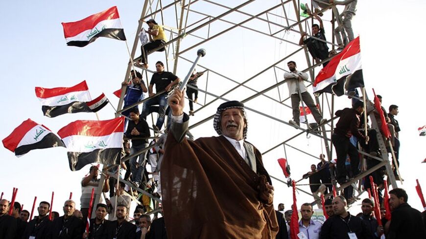 A supporter of Shi'ite cleric Moqtada al-Sadr takes part in a rally, which the participants said was against sectarianism and injustice, in Kut, 150 km (93 miles) southeast of Baghdad, March 16, 2013.    REUTERS/Wissm al-Okili (IRAQ - Tags: CIVIL UNREST TPX IMAGES OF THE DAY) - RTR3F2NB