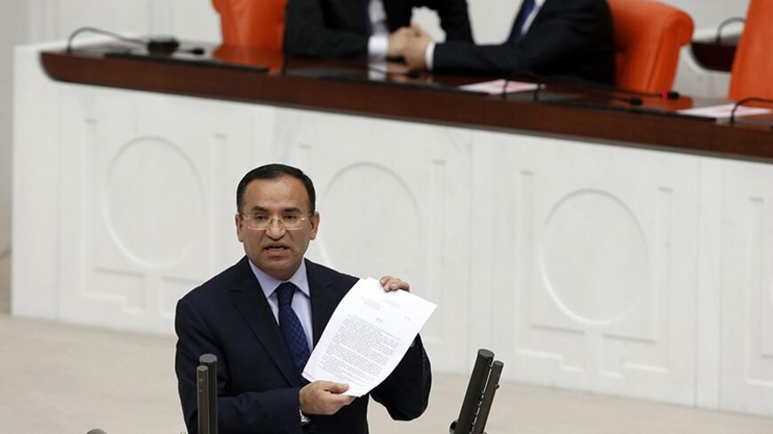 Justice Minister Bekir Bozdag addresses the Turkish Parliament during a debate in Ankara March 19, 2014. Parliament convened in the capital Ankara for the hearing of a prosecutor report allegedly outlining the role of four former ministers in a corruption scandal that became public in December 2013. REUTERS/Umit Bektas (TURKEY - Tags: POLITICS) - RTR3HRDM