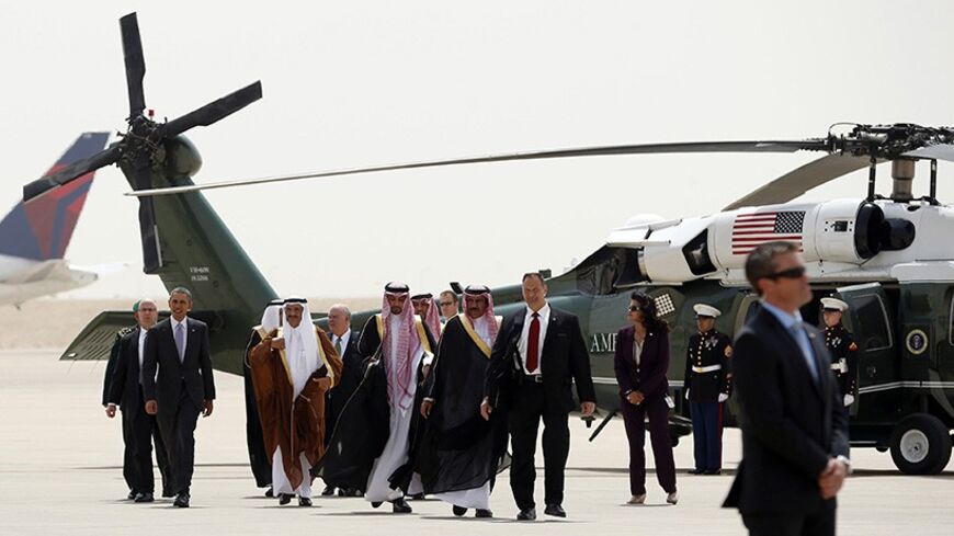 U.S. President Barack Obama (2nd L) is escorted from Marine One to Air Force One as he departs Saudi Arabia to return to Washington March 29, 2014. Obama sought to reassure Saudi King Abdullah on Friday that he would support moderate Syrian rebels and reject a bad nuclear deal with Iran, during a visit designed to allay the kingdom's concerns that its decades-old U.S. alliance had frayed.      REUTERS/Kevin Lamarque  (SAUDI ARABIA - Tags: POLITICS) - RTR3J2HK