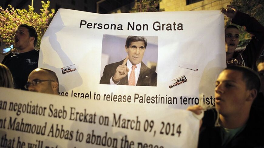 Israelis hold a sign depicting U.S. Secretary of State John Kerry during a protest outside his hotel in Jerusalem, against the release by Israel of Palestinian prisoners as a confidence-building gesture, March 31, 2014. Kerry broke from his travel schedule for the second time in a week and rushed back to the Middle East on Monday to try to salvage Israeli-Palestinian peace talks. REUTERS/Ammar Awad (JERUSALEM - Tags: POLITICS CIVIL UNREST) - RTR3JD9P
