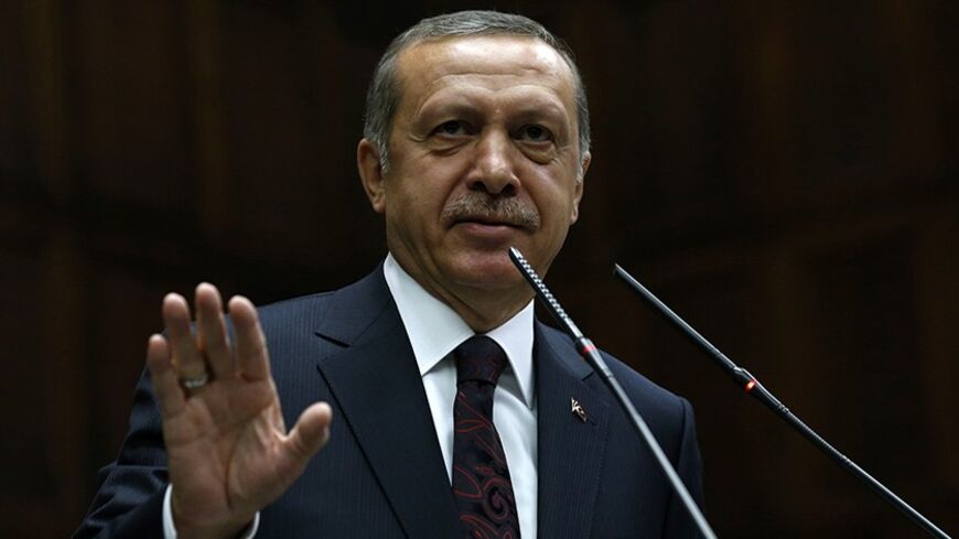 Turkey's Prime Minister Tayyip Erdogan addresses members of parliament from his ruling AK Party (AKP) during a meeting at the Turkish parliament in Ankara April 8, 2014. Turkey's first directly elected president will be a more powerful figure than the current largely ceremonial role, Prime Minister Tayyip Erdogan was quoted on Tuesday as saying, boosting expectations he may run for the post in August. Erdogan is barred by the rules of his ruling AK Party from standing for a fourth term as prime minister and