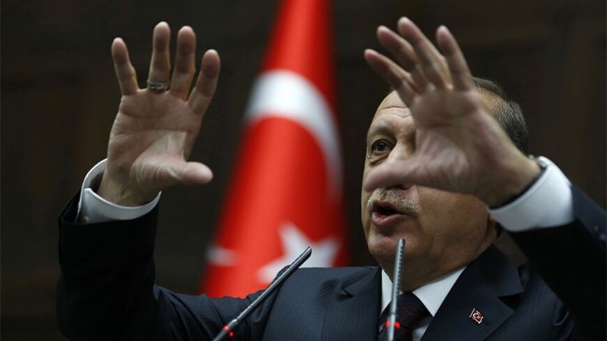 Turkey's Prime Minister Tayyip Erdogan addresses members of parliament from his ruling AK Party (AKP) during a meeting at the Turkish parliament in Ankara April 8, 2014. Turkey's first directly elected president will be a more powerful figure than the current largely ceremonial role, Prime Minister Tayyip Erdogan was quoted on Tuesday as saying, boosting expectations he may run for the post in August. Erdogan is barred by the rules of his ruling AK Party from standing for a fourth term as prime minister and