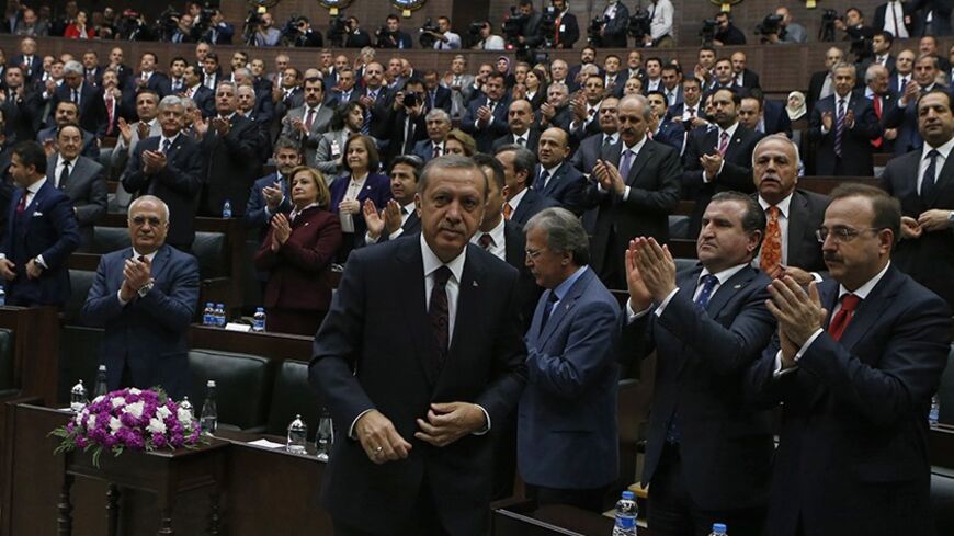 Turkey's Prime Minister Tayyip Erdogan leaves his seat to address members of parliament from his ruling AK Party (AKP) during a meeting at the Turkish parliament in Ankara April 8, 2014. Turkey's first directly elected president will be a more powerful figure than the current largely ceremonial role, Prime Minister Tayyip Erdogan was quoted on Tuesday as saying, boosting expectations he may run for the post in August. Erdogan is barred by the rules of his ruling AK Party from standing for a fourth term as p