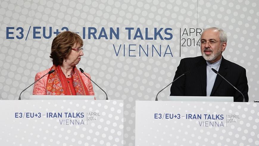 European Union foreign policy chief Catherine Ashton (L) and Iranian Foreign Minister Mohammad Javad Zarif address a news conference after talks in Vienna April 9, 2014. Six world powers and Iran will need "a lot of intensive work" to bridge differences during talks over Tehran's nuclear programme, Ashton said on Wednesday after their latest meeting. REUTERS/Heinz-Peter Bader  (AUSTRIA - Tags: POLITICS ENERGY TPX IMAGES OF THE DAY) - RTR3KKLC