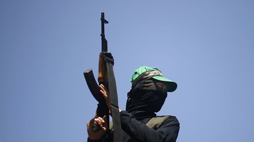 A Hamas militant takes part in a rally marking Palestinian Prisoner Day, in Gaza City April 17, 2014. Israel holds some 5,000 Palestinians it accuses of committing or planning violence against it.  REUTERS/Mohammed Salem (GAZA - Tags: POLITICS) - RTR3LNH6
