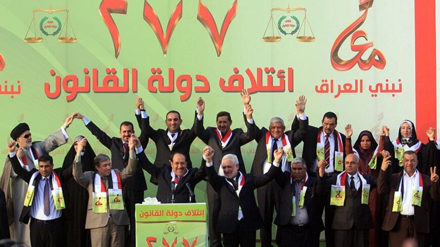 Iraq's Prime Minister Nuri al-Maliki (front 3rd L) takes part in a ceremony to announce his election platform as well as promote candidates of State of Law coalition in Kerbala, southwest of Baghdad, April 17, 2014. REUTERS/Mushtaq Muhammed (IRAQ - Tags: ELECTIONS POLITICS) - RTR3LQ8G