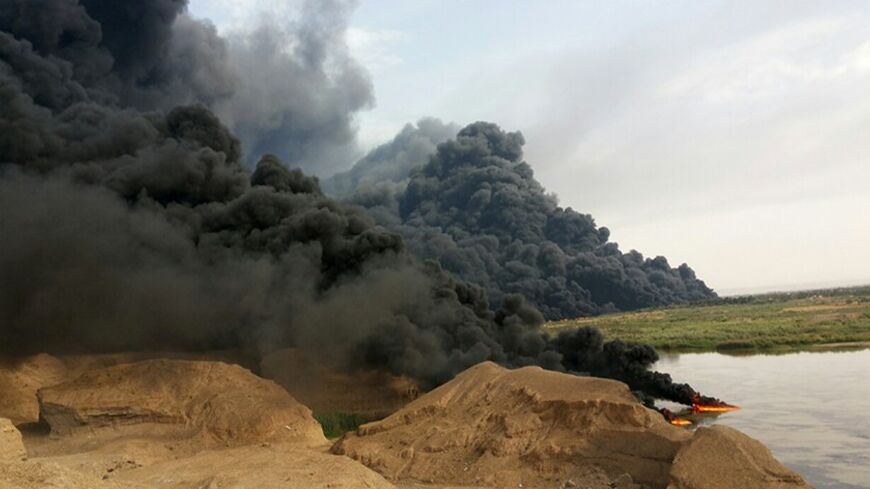 A cloud of smoke rises from an oil pipeline in Tikrit, north of Baghdad, April 17, 2014. A rusting pipeline that runs from the Kirkuk oilfields to the Baiji refinery in Salahuddin province leaked a large amount of oil into the Tigris River, according to a Northern Oil Company official who asked not be named. The spill stirred panic after someone set the oil ablaze, sending huge clouds of smoke into the provincial capital Tikrit, according to city residents. Ambulances evacuated residents with difficulty bre