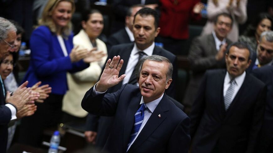 Turkey's Prime Minister Tayyip Erdogan greets members of parliament from his ruling AK Party (AKP) as he arrives a meeting at the Turkish parliament in Ankara April 29, 2014. REUTERS/Umit Bektas (TURKEY - Tags: POLITICS) - RTR3N1W3