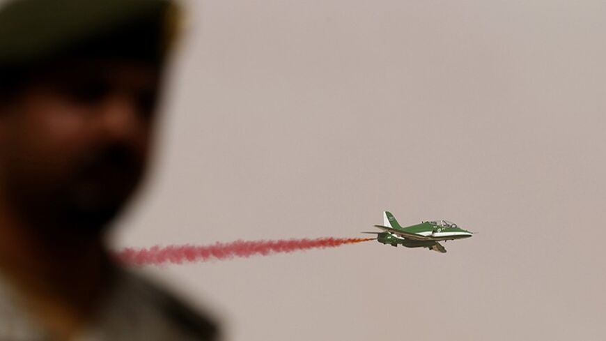 A member of Saudi security forces attends Abdullah's Sword military drill as a jet flies by in Hafar Al-Batin, near the border with Kuwait REUTERS/Faisal Al Nasser (SAUDI ARABIA - Tags: MILITARY) - RTR3N4AM