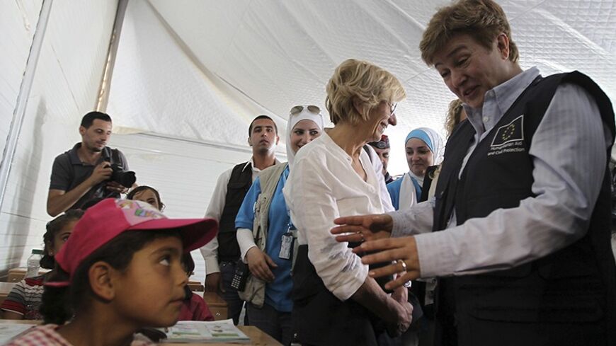 European Union Commissioner for International Cooperation, Humanitarian Aid and Crisis Response Kristalina Georgieva (R) and Italy's Foreign Minister Emma Bonino (2nd R) speak to students during their visits to a UNICEF school at the Al Zaatri refugee camp in the Jordanian city of Mafraq, near the border with Syria June 25, 2013. REUTERS/Muhammad Hamed (JORDAN - Tags: POLITICS SOCIETY EDUCATION) - RTX11035