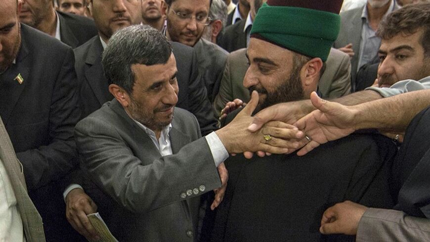 Iranian President Mahmoud Ahmadinejad visits the holy shrine of Imam Abbas in Kerbala, 110 km (68 miles) south of Baghdad, July 19, 2013. REUTERS/ Ahmed al-Husseini /Pool (IRAQ - Tags: RELIGION POLITICS) - RTX11SBV