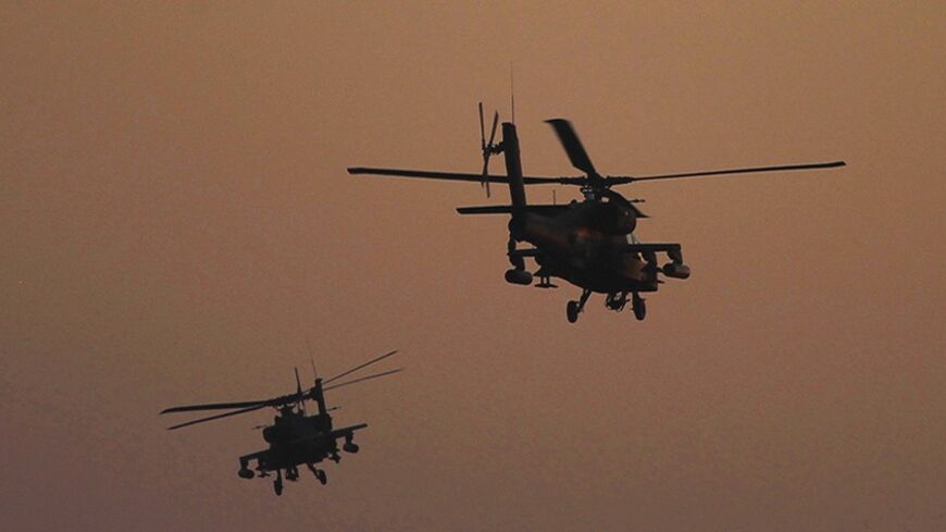 Apache helicopters fly over Tahrir Square during a protest to support the army, in Cairo July 26, 2013. Ousted Egyptian president Mohamed Mursi is under investigation for an array of charges including murder, the state news agency said on Friday, stoking tensions as opposing political camps took to the streets. Confirming the potential for bloodshed, two men were killed in confrontations in Egypt's second city Alexandria and a further 19 were hurt, Mena news agency reported. REUTERS/Amr Abdallah Dalsh (EGYP