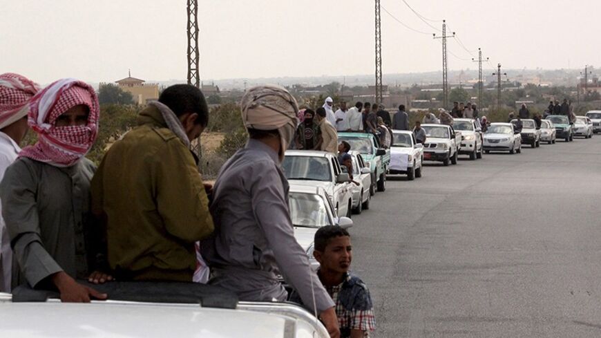 A funeral convoy carrying the bodies of four Islamist militants drives through Sheikh Zuweid, in the north of the Sinai peninsula, August 10, 2013. The four Islamist militants were killed by an air strike that their comrades said had been done by an Israeli drone but which state media said was the work of an Egyptian army helicopter. REUTERS/ Stringer (EGYPT - Tags: CIVIL UNREST POLITICS) - RTX12G5D
